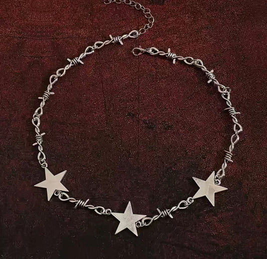 Necklace, Barb wire, Star pendant, Edgy, Statement piece, Jewelry, Rebel, Unique design, Fashion, Resilience, Strength, Bold, Intricate, Symbolic, Adjustable chain, Trendy, Accessories, Gothic, Rock-inspired, Conversation starter