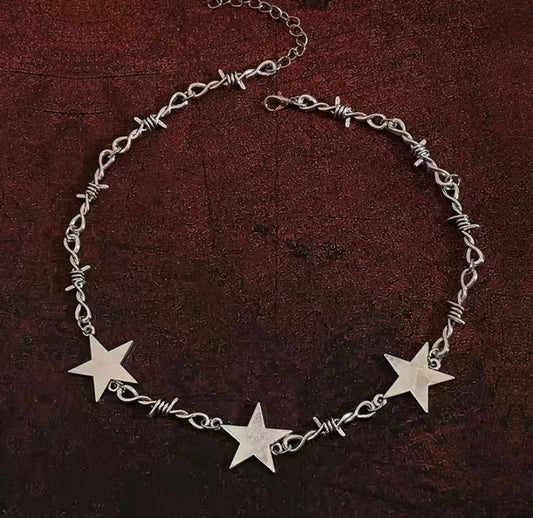  Necklace, Barb wire, Star pendant, Edgy, Statement piece, Jewelry, Rebel, Unique design, Fashion, Resilience, Strength, Bold, Intricate, Symbolic, Adjustable chain, Trendy, Accessories, Gothic, Rock-inspired, Conversation starter